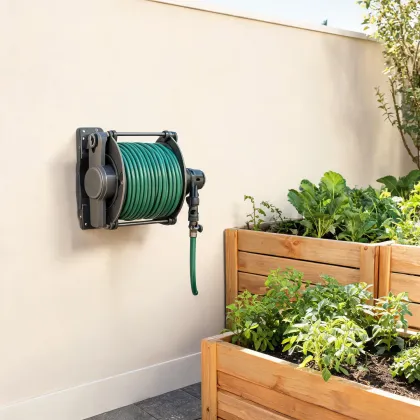 Retractable hose reel on a garden wall